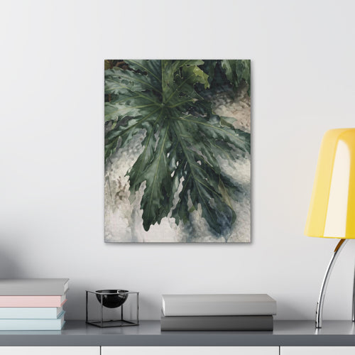  A Little Wild botanical canvas above a gray cabinet styled with books and a yellow table lamp.