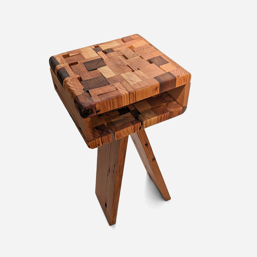 Connie side table with a woven reclaimed wood block top in mixed brown tones and an angled raw wood leg base, on a light grey background