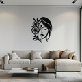 Black metal laser-cut wall art of a woman's face in profile with flowing hair and large floral blooms, mounted above a cream sectional sofa in a bright modern living room
