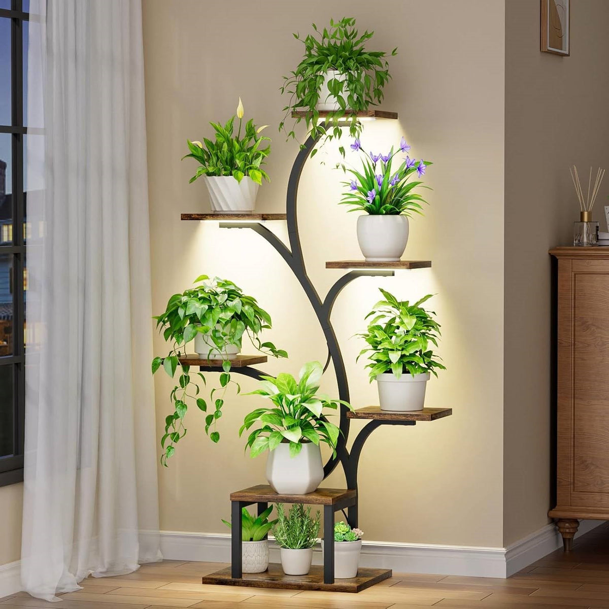 Tree-shaped plant stand with full-spectrum grow lights glowing in a dimly lit room at dusk