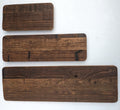 Three Groove Shelves reclaimed wood backer panels in small, medium, and large sizes, showing natural grain and aged dark brown texture, on a white background