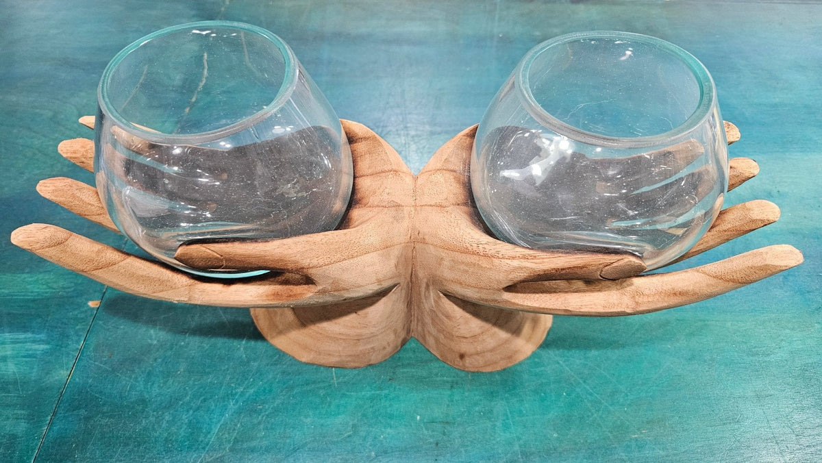 Wooden holder with two glass terrariums on a teal surface